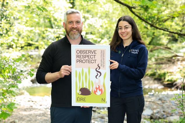 Minister O'Sullivan with Observe, Respect, Protect image of new stamp